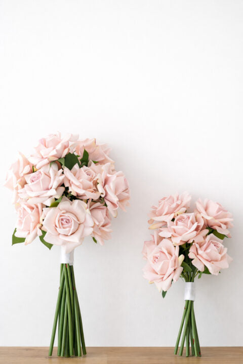 Bride and bridesmaid compare bouquet new